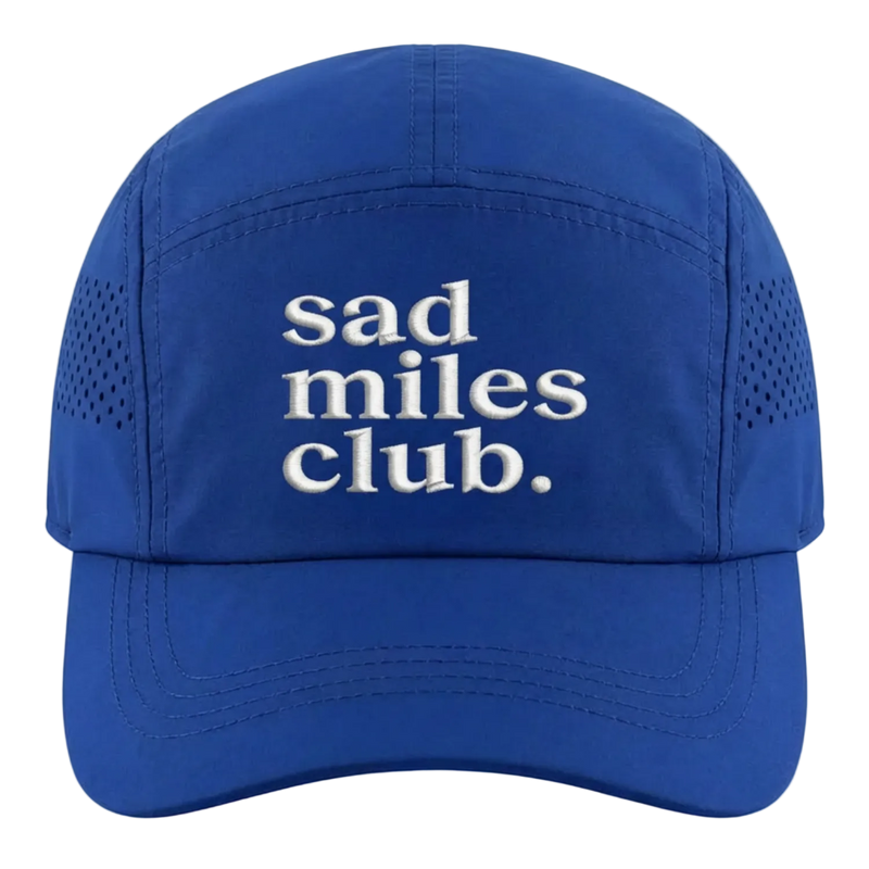 Blue cap with 'sad miles club.' text on a white background