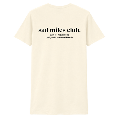 Beige t-shirt with 'sad miles club' text on a white background