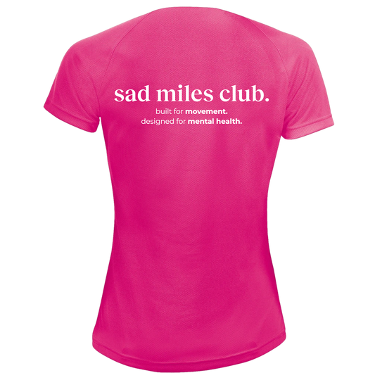 Pink t-shirt with 'sad miles club' text on a white background
