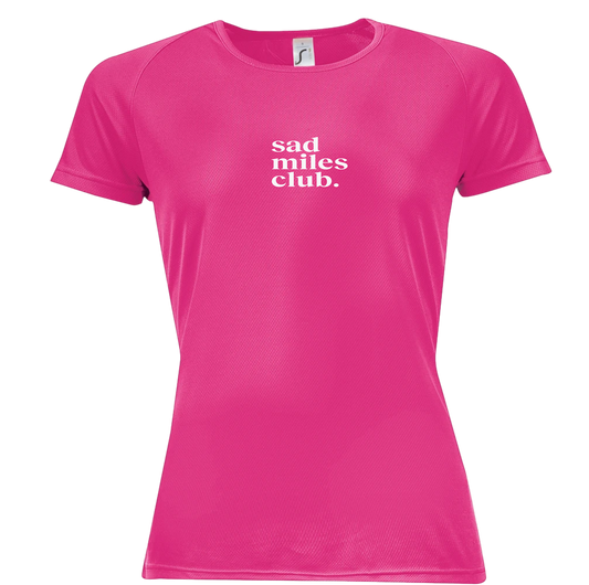 Pink t-shirt with 'sad miles club' text on a white background