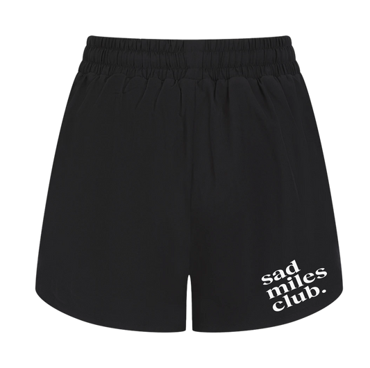 Black shorts with 'sad miles club' text on a white background