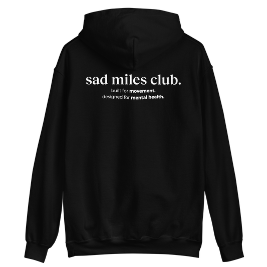 Black hoodie with 'sad miles club' text on the back against a white background
