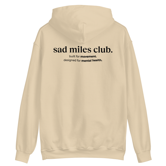 Beige hoodie with 'sad miles club' text on the back against a white background